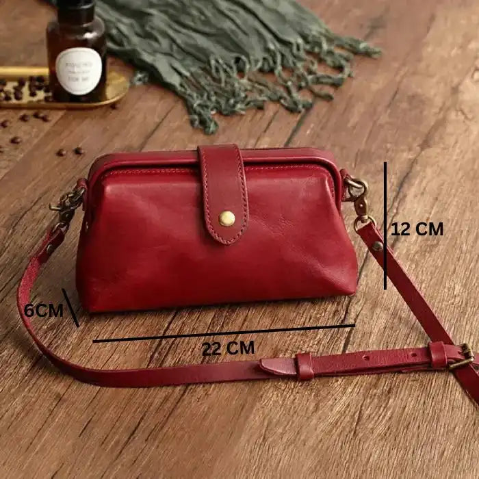 Red leather shoulder bag measuring 22 cm wide, 12 cm high and 6 cm deep, ideal for style and functionality, front view.