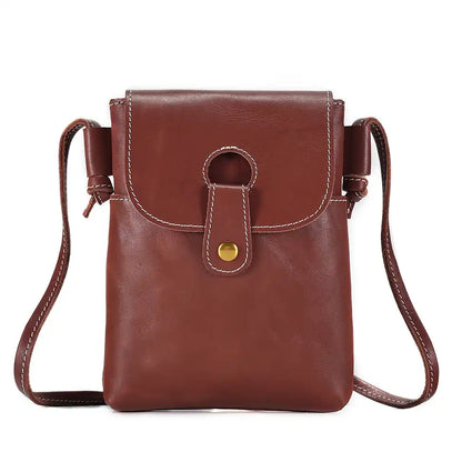 reddish brown women's leather crossbody bag, with long handle and elegant clasp - front view.