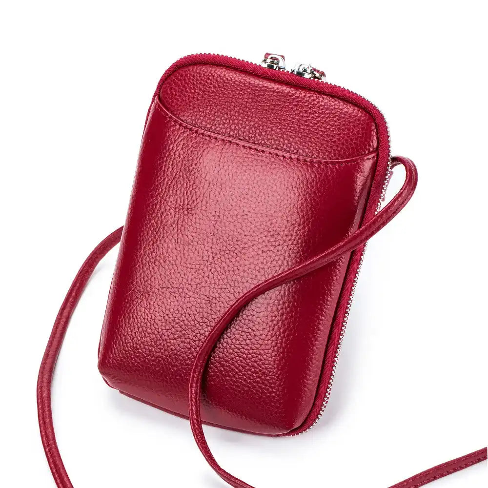 Stylish red leather crossbody bag with a sleek design and leather strap - front view.