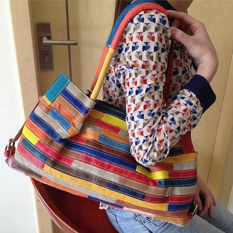 a colorful leather bag held by a woman, highlighting its vibrant patchwork design.