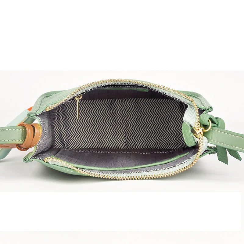 Detailed view of the interior design of a  green crossbody bag with a stylish patterned lining 