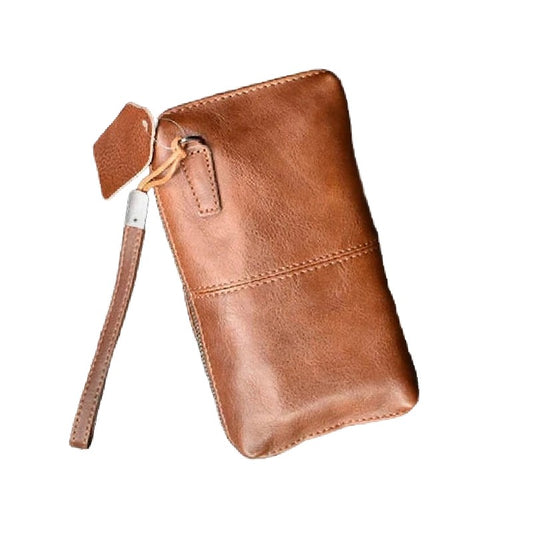 Brown leather wristlet with strap on a white background, front view.