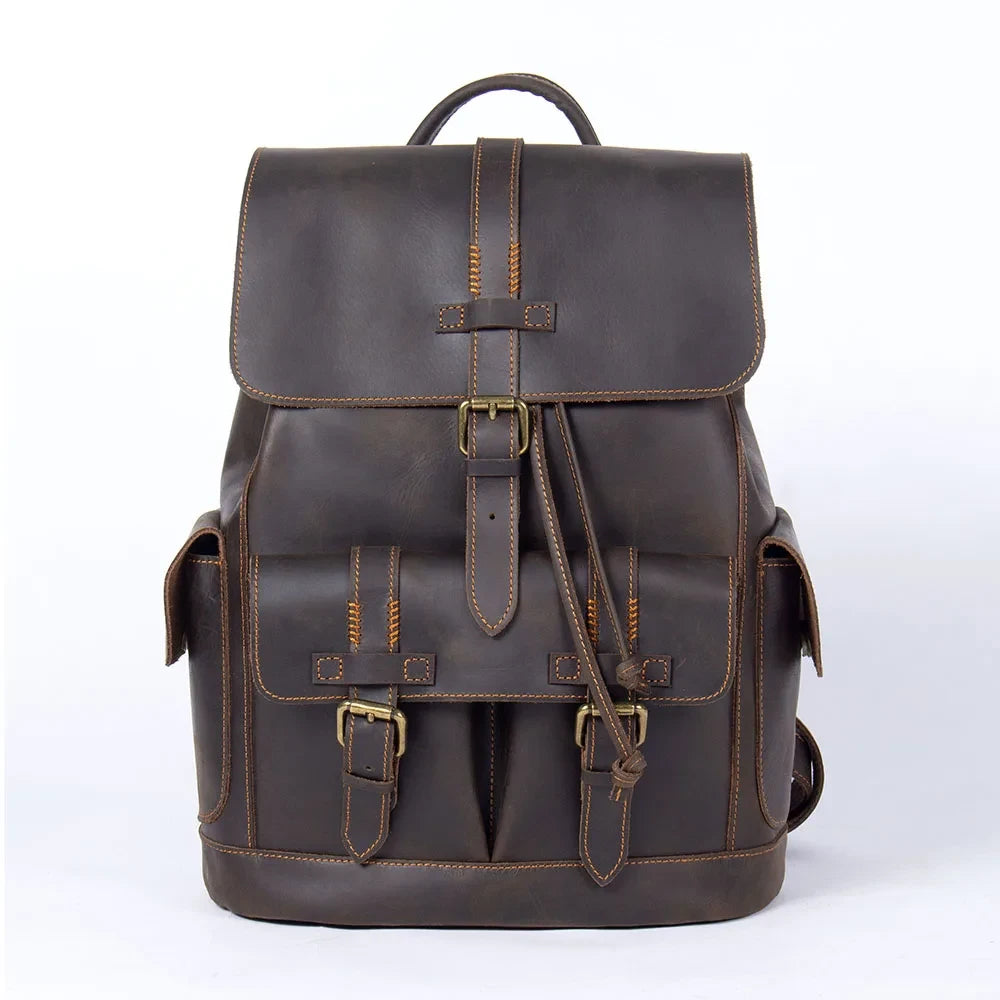 Elegant dark brown leather backpack, ideal for travel, with buckle and visible stitching details and pockets - front view
