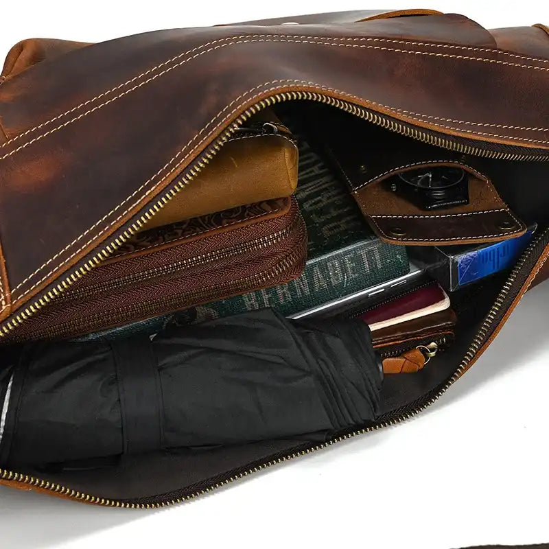 Inside view of a leather shoiulder bag showcasing organized compartments and contents.