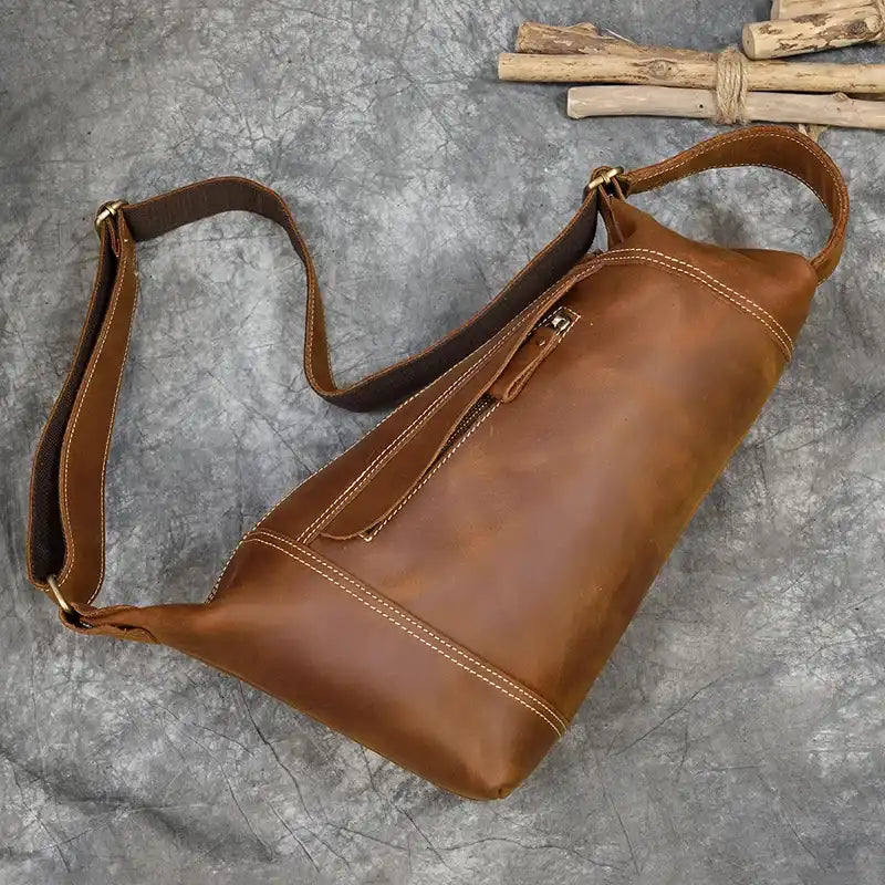 Stylish light brown leather shoulder bag with adjustable strap - back view.