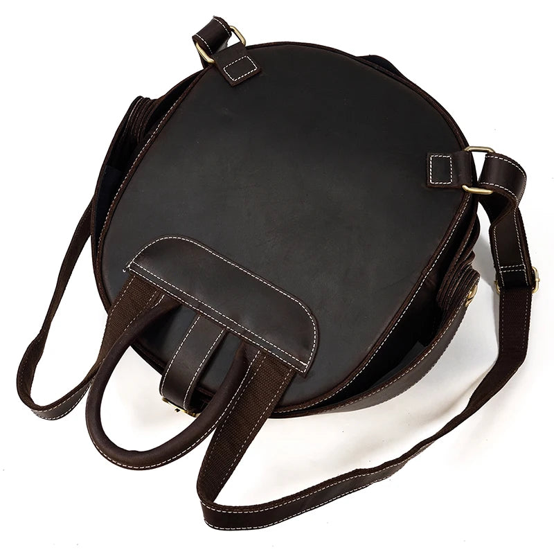 Back view of a black leather backpack with adjustable straps and elegant handle.