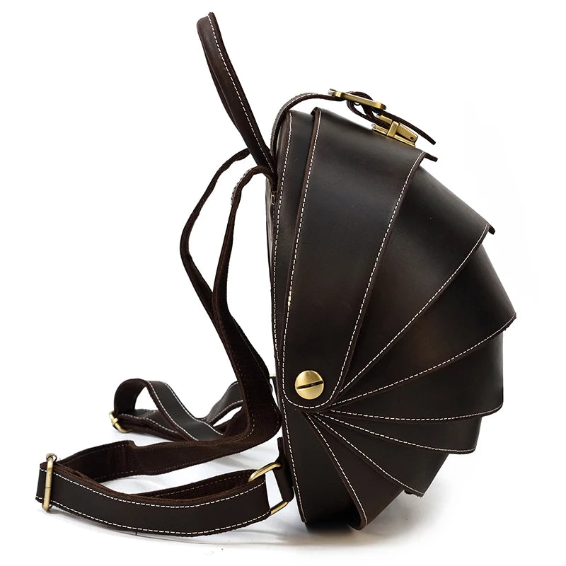 Black leather backpack with distinctive fan-shaped design and straps - side view