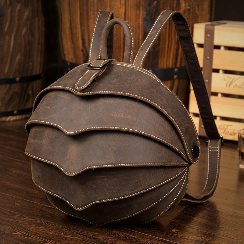Brown leather backpack with wavy design and adjustable straps - front view.