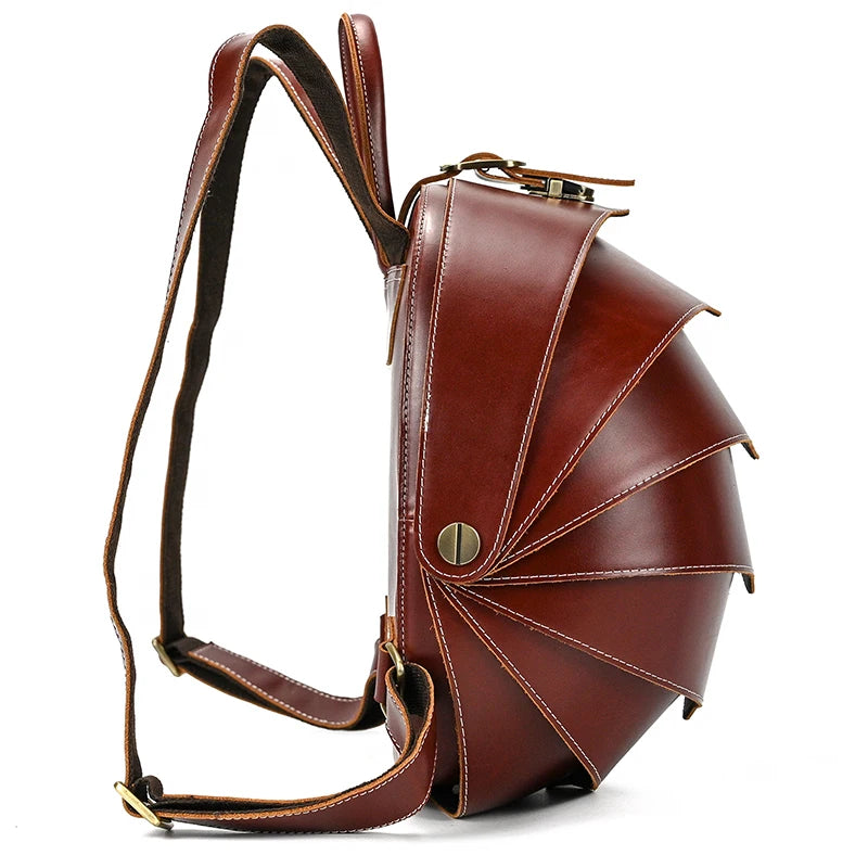 Brown tone leather backpack with distinctive fan-shaped design and straps - side view