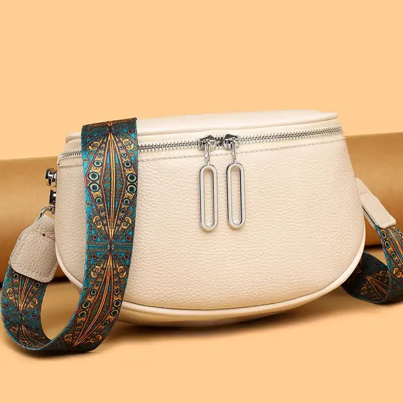 white leather shoulder bag with colored patterned strap.