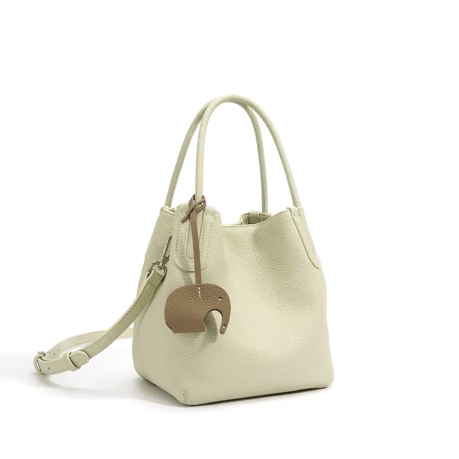 A stylish white leather bucket bag with a unique elephant charm - front view.