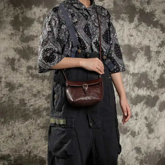 model wearing a coffee brown leather crossbody bag with style.