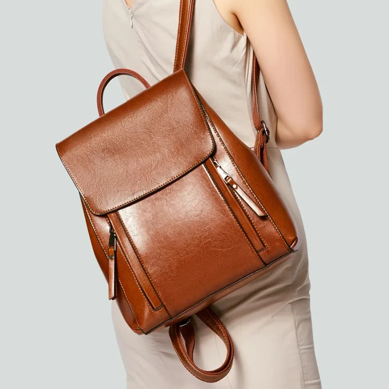 Elegant brown leather backpack, worn by a modern women.