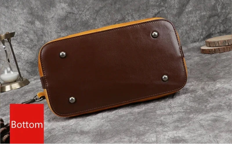 bottom view of a leather bag, highlighting the material and accessories.