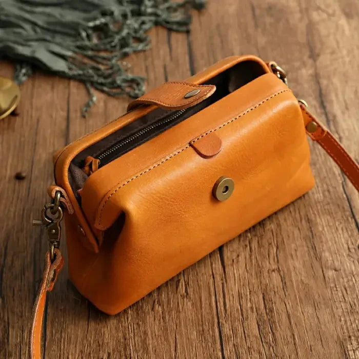 An elegant yellow leather shoulder bag, highlighting its classic design and smooth texture, front view.