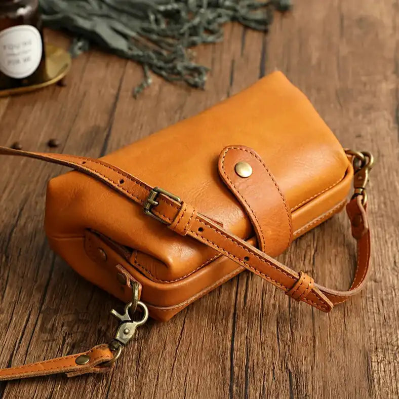 Elegant yellow leather shoulder bag, with adjustable strap and practical design, top view.