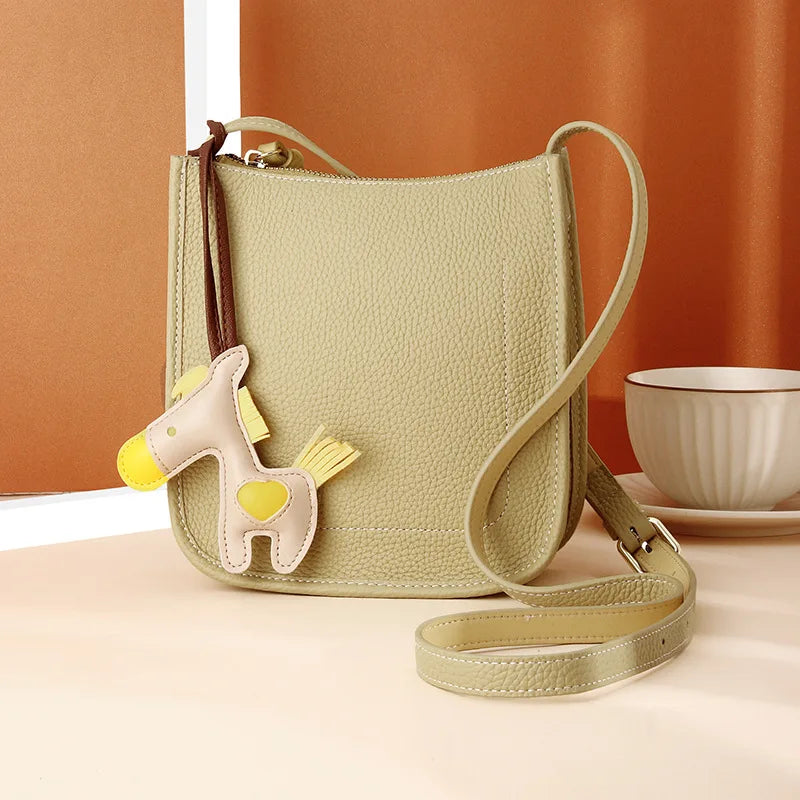 Front view of a cute yellow crossbody bag perfect for everyday use with a whimsical horse charm