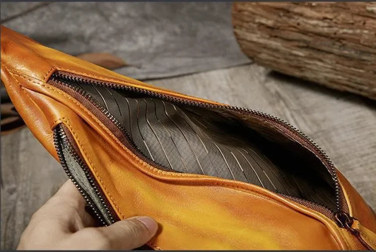 close-up view of the interior of an yellow leather bag with a zipper showcasing its interior design.