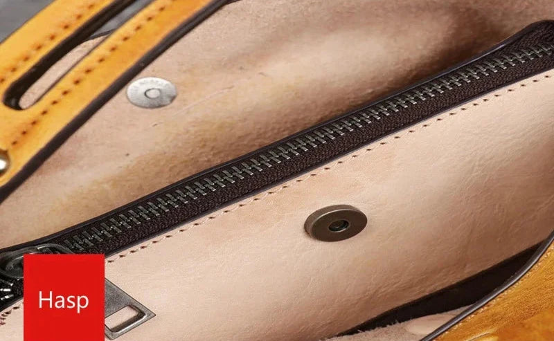 Detailed view of a hasp closure on a bag, highlighting the zipper and the internal texture of the material.