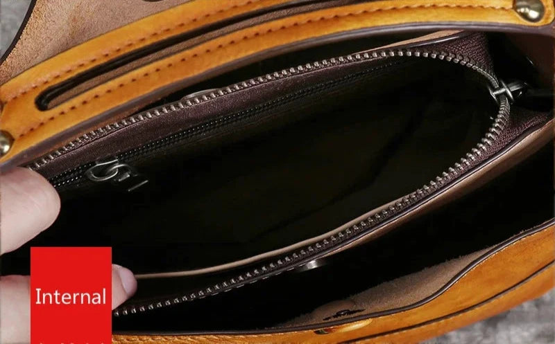 interior view of a leather bag, showing pockets and zippers compartments.